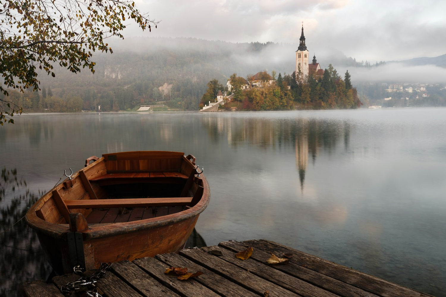 Misty mountain lake with a canoe